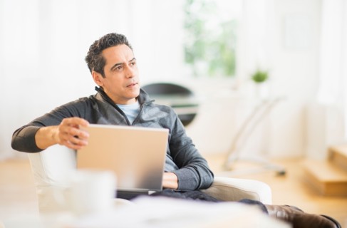 Portrait of man working on laptop at home