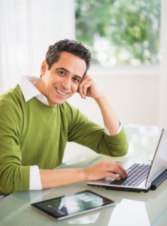 Portrait of man working on laptop at home