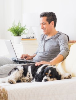 View of mature man using laptop at home