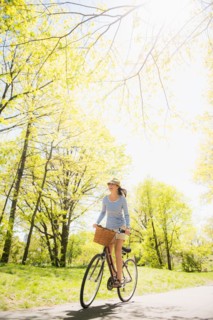 Mid adult woman riding bicycle