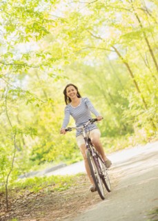 Mid adult woman riding bicycle