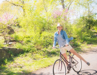 Mid adult woman riding bicycle