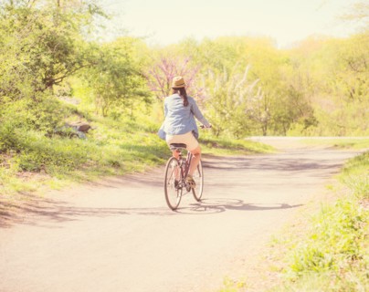 Mid adult woman riding bicycle