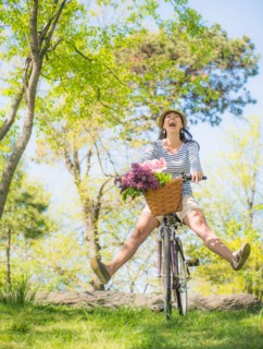 Mid adult woman riding bicycle