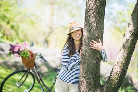 Portrait of mid adult woman embracing tree