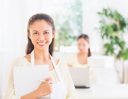 Portrait of mid adult women holding document