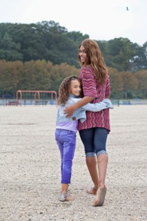 Woman and her daughter (8-9) on playground
