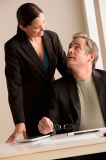 Mature man and woman working together