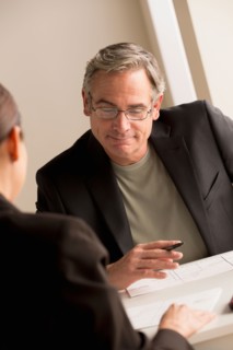 Mature man working with woman