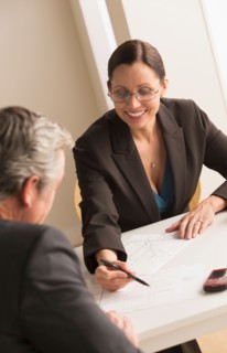 Mature woman working with mature man
