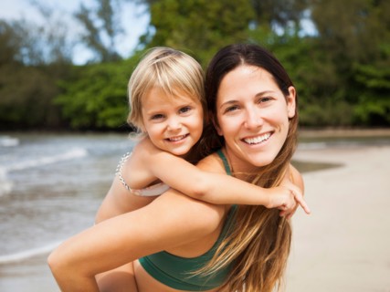 Mother with daughter (2-3) on beach