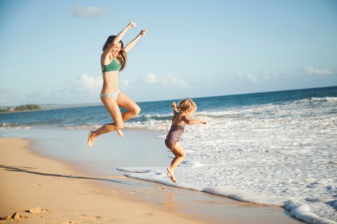 Mother with daughter (2-3) playing on beach