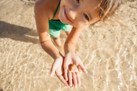 Girl (6-7) playing on beach