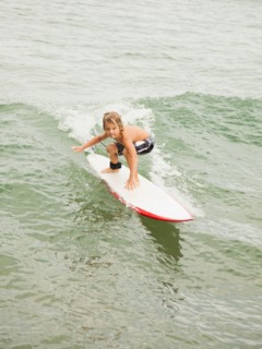 Boy (6-7) surfing