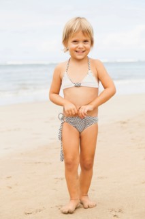 Portrait of girl (2-3) standing on beach