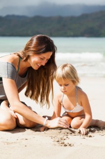 Mother playing with daughter (2-3) on beach