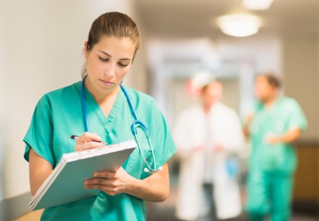 Female doctor in hospital hallway.