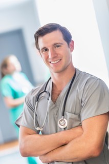 Portrait of male doctor in hospital hallway.