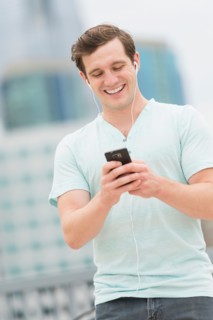 Man listening to music on smartphone.