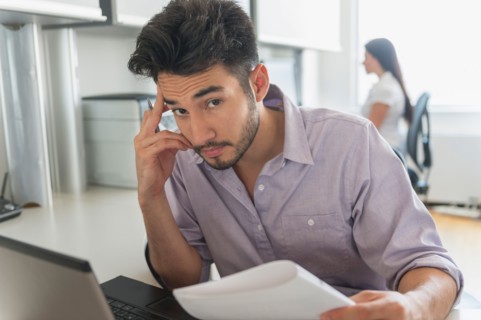 Portrait of businessman at work in office.