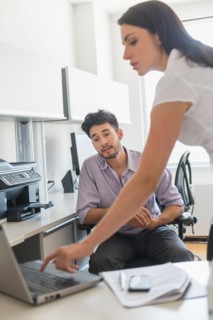 Business man and woman at work in office.