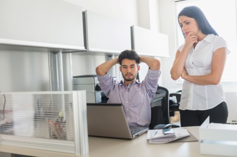 Business man and woman at work in office.
