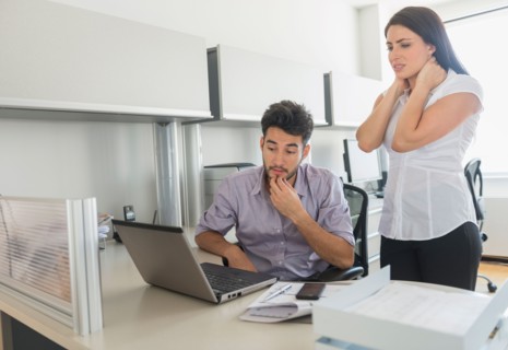 Business man and woman at work in office.