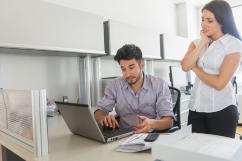Business man and woman at work in office.