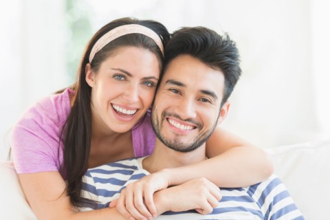 Portrait of young couple smiling.