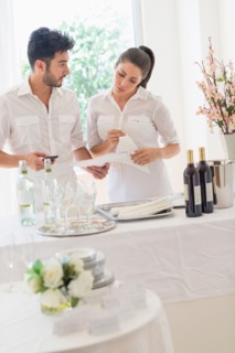 Business owners preparing dining table.