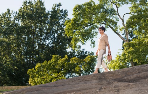 Mature woman walking on rock.