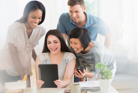 Group of young friends using digital tablet.