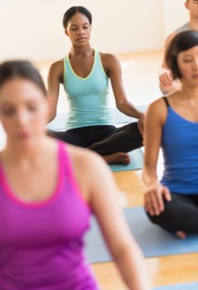 People training yoga in gym.