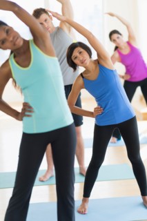 People stretching in gym.