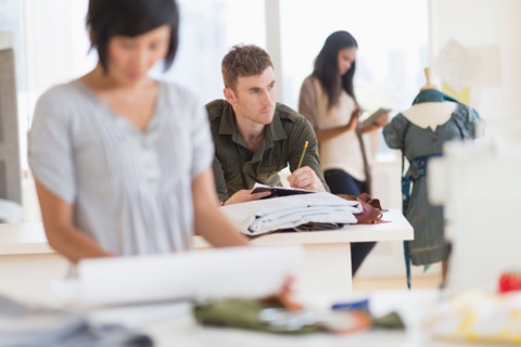 People working in fashion studio.