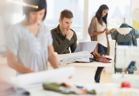 People working in fashion studio.
