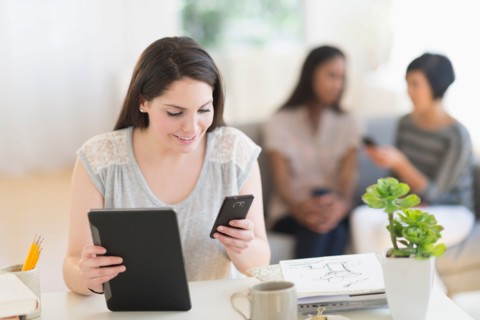 Woman using digital tablet and mobile phone.