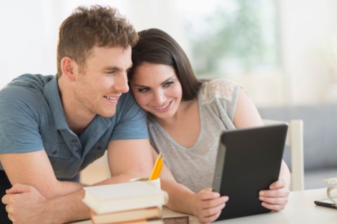 Couple using digital tablet.