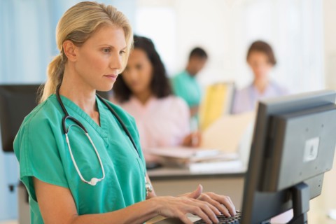 Doctor working at desks in hospital.