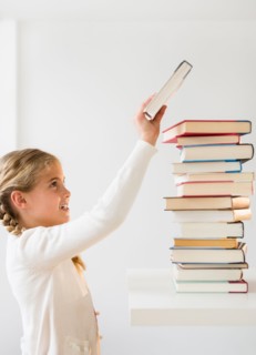 Portrait of girl (8-9) holding book