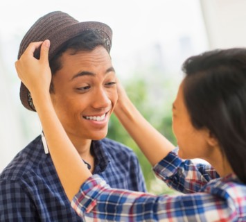 Young man trying on hat