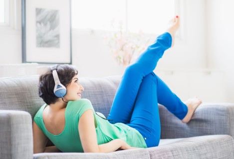 Young woman listening to music at home