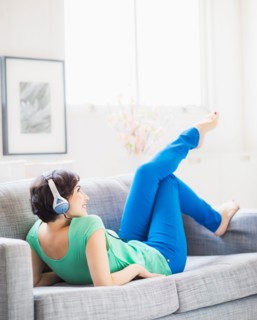 Young woman listening to music at home