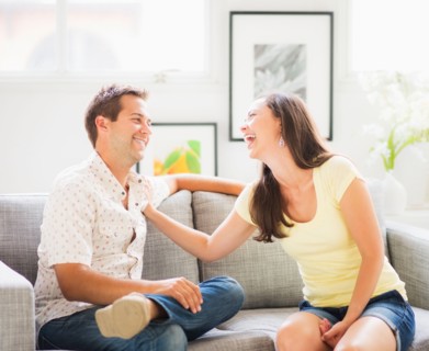 Portrait of playful couple on sofa