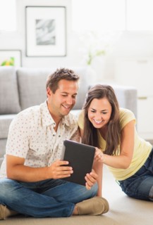 Portrait of couple using digital tablet