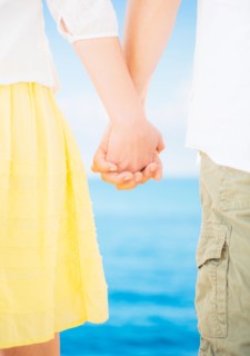 Studio Shot Mid section of couple standing and holding hands
