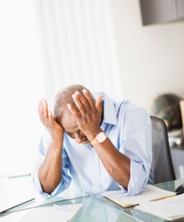 Portrait of tired senior man in office