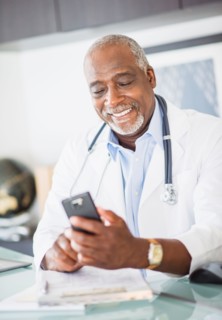 Portrait of doctor text messaging