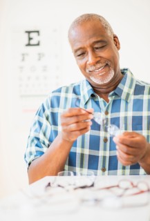Man looking at glasses in store