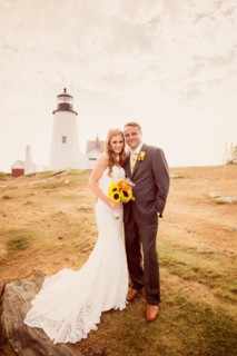 Portrait of married couple, lighthouse in background
